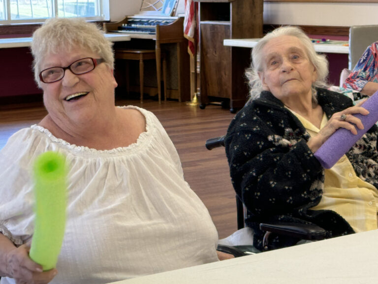 Residents enjoying activities in Coffman Nursing Home's recreation room