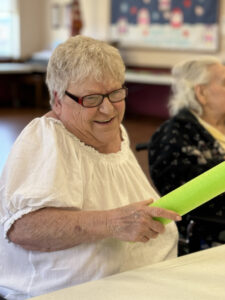 A resident enjoys a lively activity in our recreation room