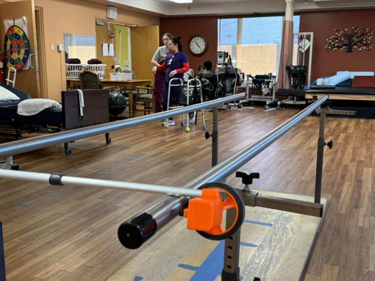 Physical therapy equipment in a rehabilitation center, including exercise bands, therapy balls, and resistance machines.