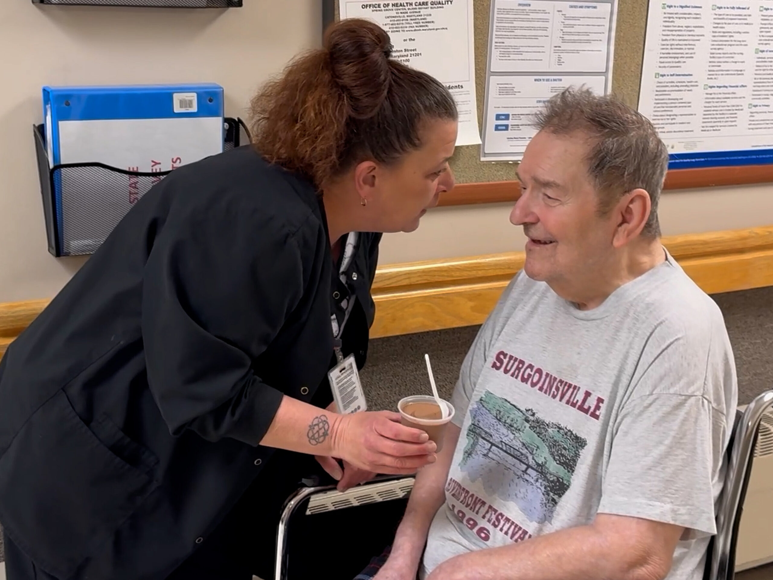 Coffman Nursing Home staff sharing ice cream with a resident in their care