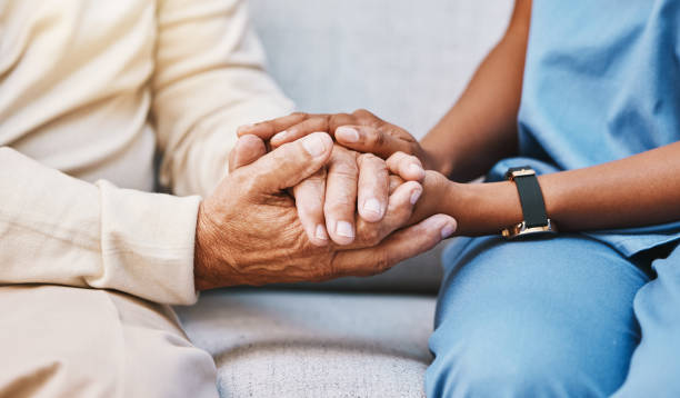 caregiver holding hands with an assisted living resident